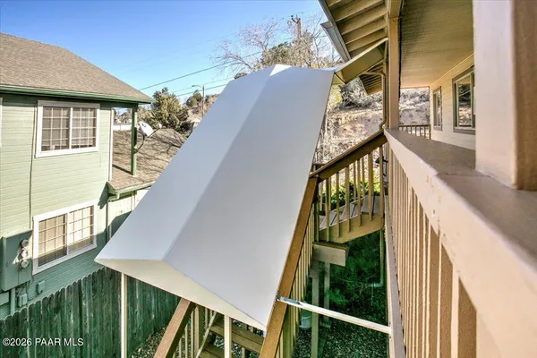 a view of balcony with wooden floor and fence