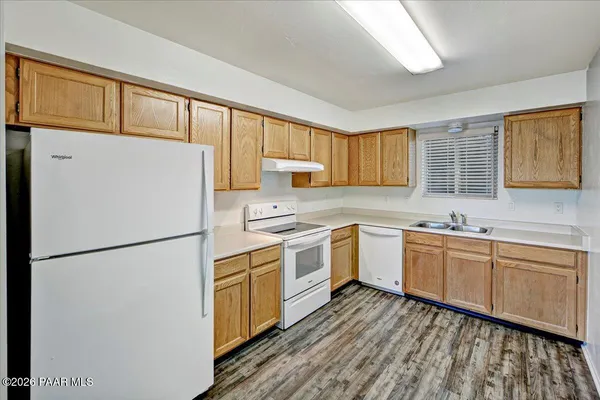 a kitchen with a refrigerator a sink and cabinets