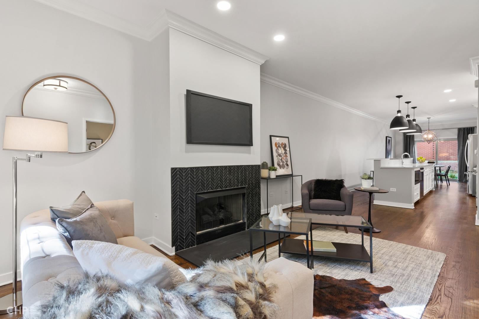1354 West Fillmore Street, Unit A Chicago, IL 60607 - Photo 3 of 15 a living room with furniture a flat screen tv and a fireplace