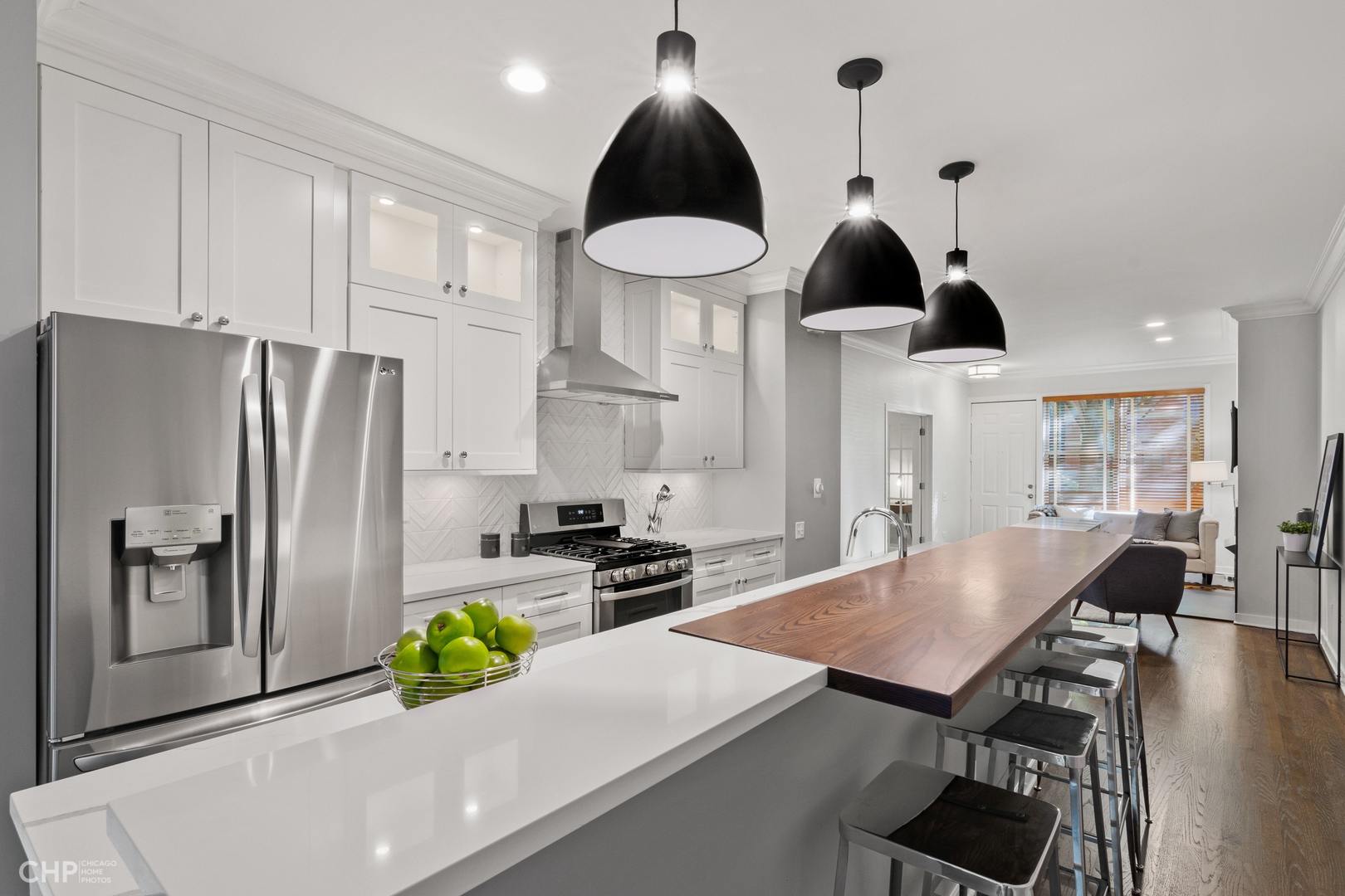 1354 West Fillmore Street, Unit A Chicago, IL 60607 - Photo 5 of 15 a kitchen with stainless steel appliances a dining table chairs and stove top oven