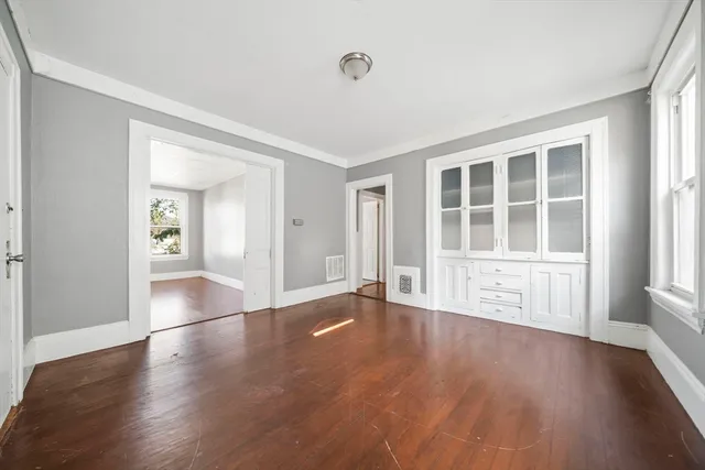 wooden floor in an empty room with a window