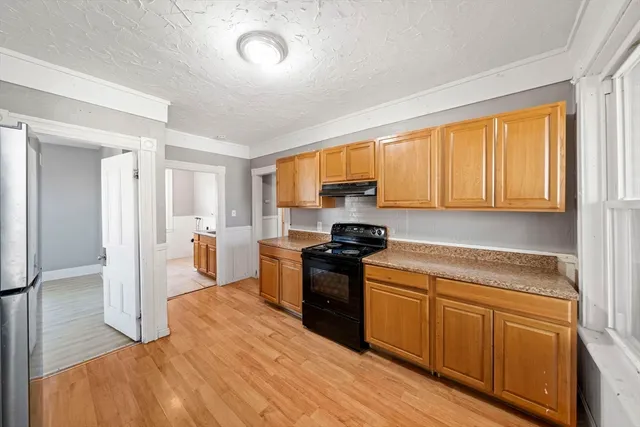 a kitchen with a stove a sink and a refrigerator