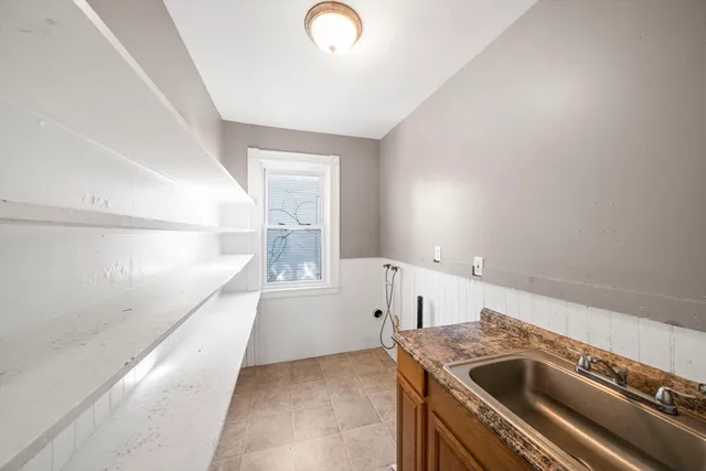 a view of a kitchen that shows a sink washer and dryer