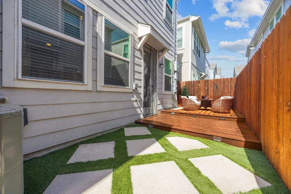 a view of a patio with a table and chairs and wooden floor
