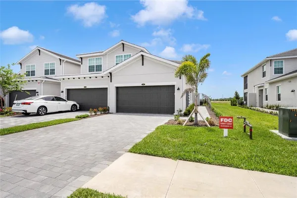 a front view of a house with a yard and garage