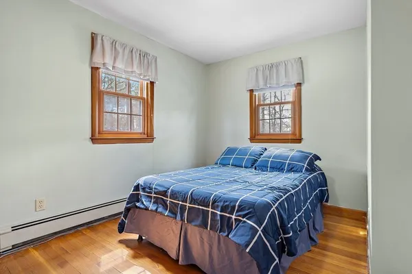 a bed sitting in a bedroom next to a window