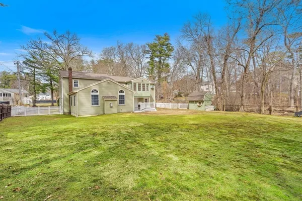 a view of a white house with a yard