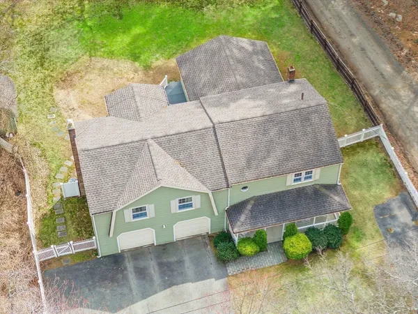 an aerial view of a house with a yard and sitting area