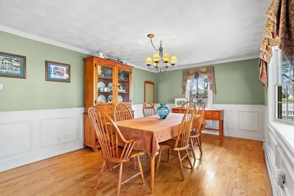 a view of a dining room with furniture and wooden floor