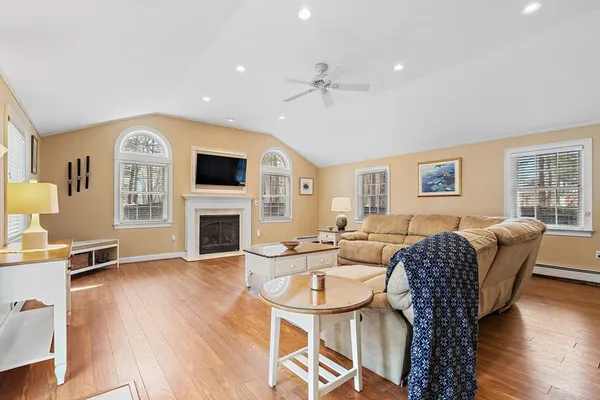 a view of a livingroom with furniture window and wooden floor