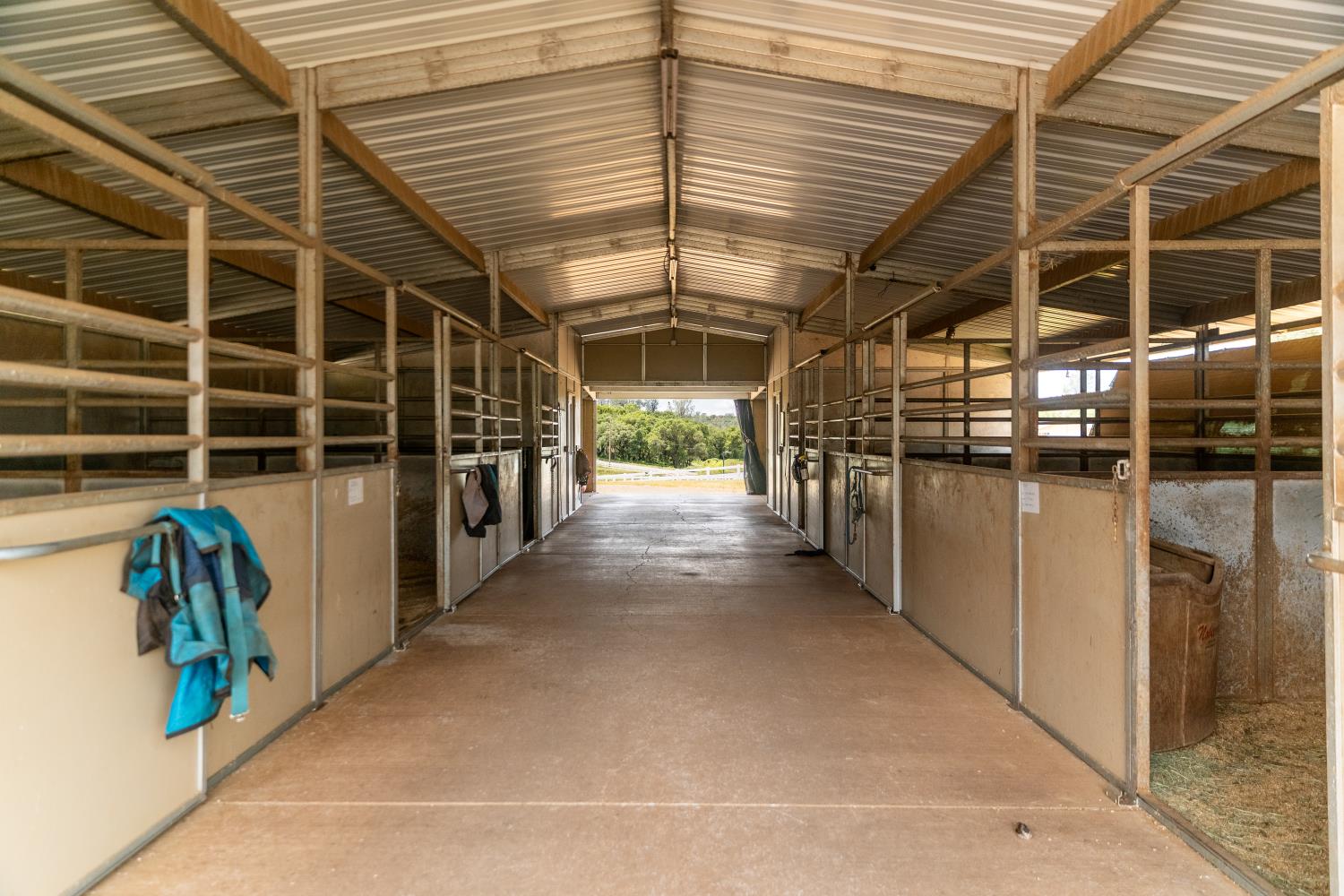 20945 Bear Hollow Road Grass Valley, CA 95949 - Photo 21 of 72 6-stall fully matted mare motel with feed & tack rooms and hay storage bay