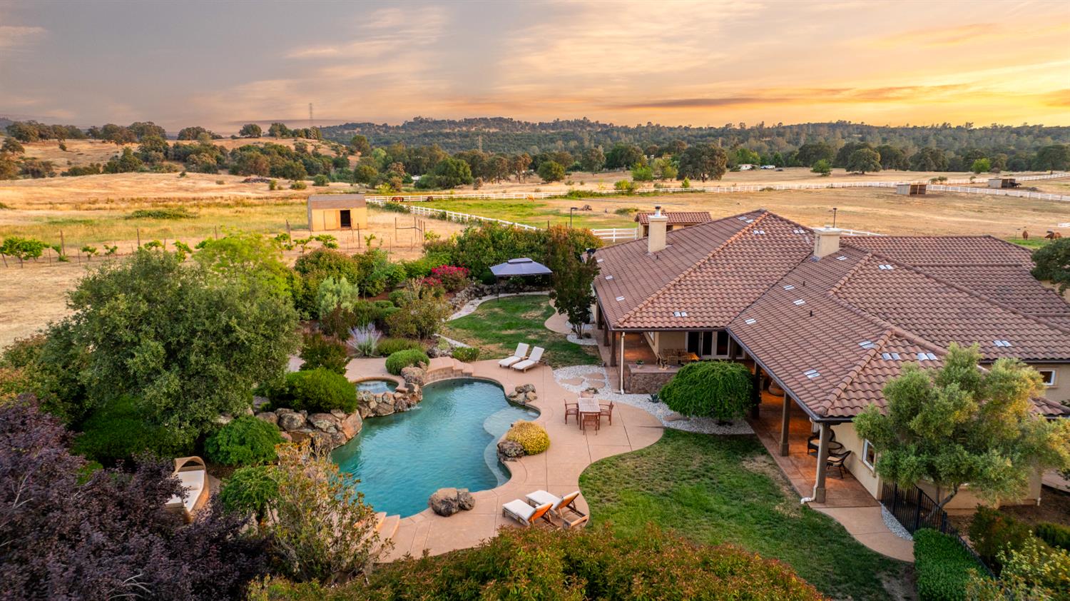 20945 Bear Hollow Road Grass Valley, CA 95949 - Photo 43 of 72 Lovely outdoor entertaining and lounging area with vineyard beyond and surrounded by pastures