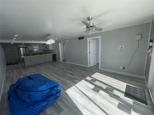 en empty room with wooden floor and window