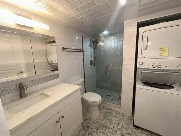 a bathroom with a sink toilet and shower