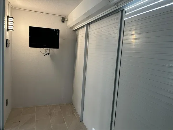 a view of a porch with furniture and a yard