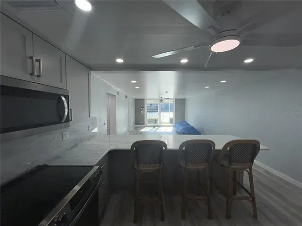 a kitchen with granite countertop sink table and chairs