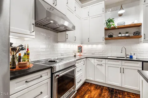 a kitchen with stainless steel appliances granite countertop a sink and cabinets
