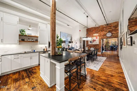 a kitchen with sink cabinets and dining table