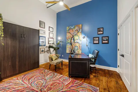a living room with furniture and a lamp