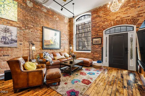 a dining room with furniture and a rug