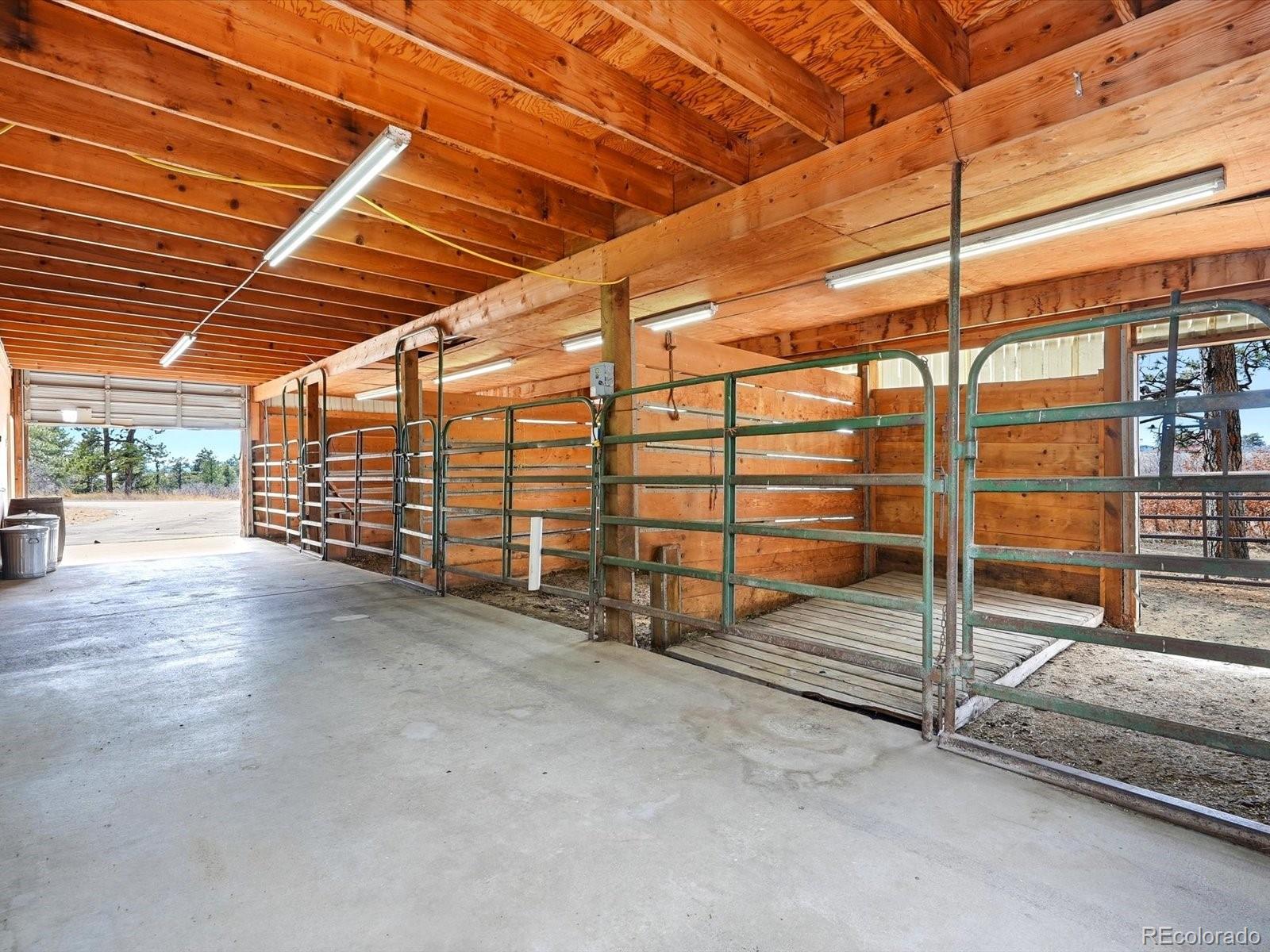 7750 East Greenland Road Franktown, CO 80116 - Photo 15 of 48 a view of an empty room with wooden walls