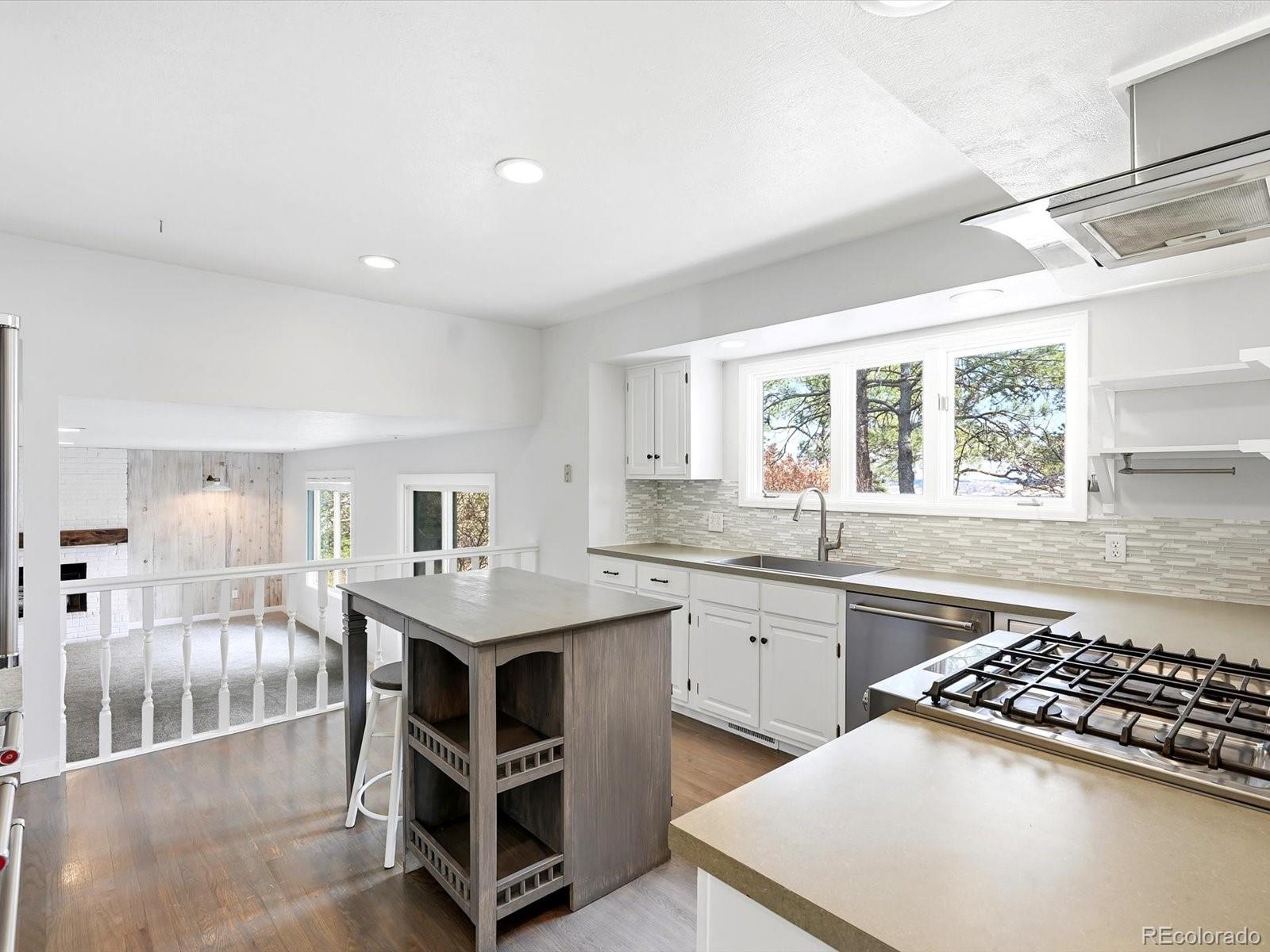 7750 East Greenland Road Franktown, CO 80116 - Photo 24 of 48 a kitchen with stainless steel appliances granite countertop a stove a sink dishwasher and a refrigerator