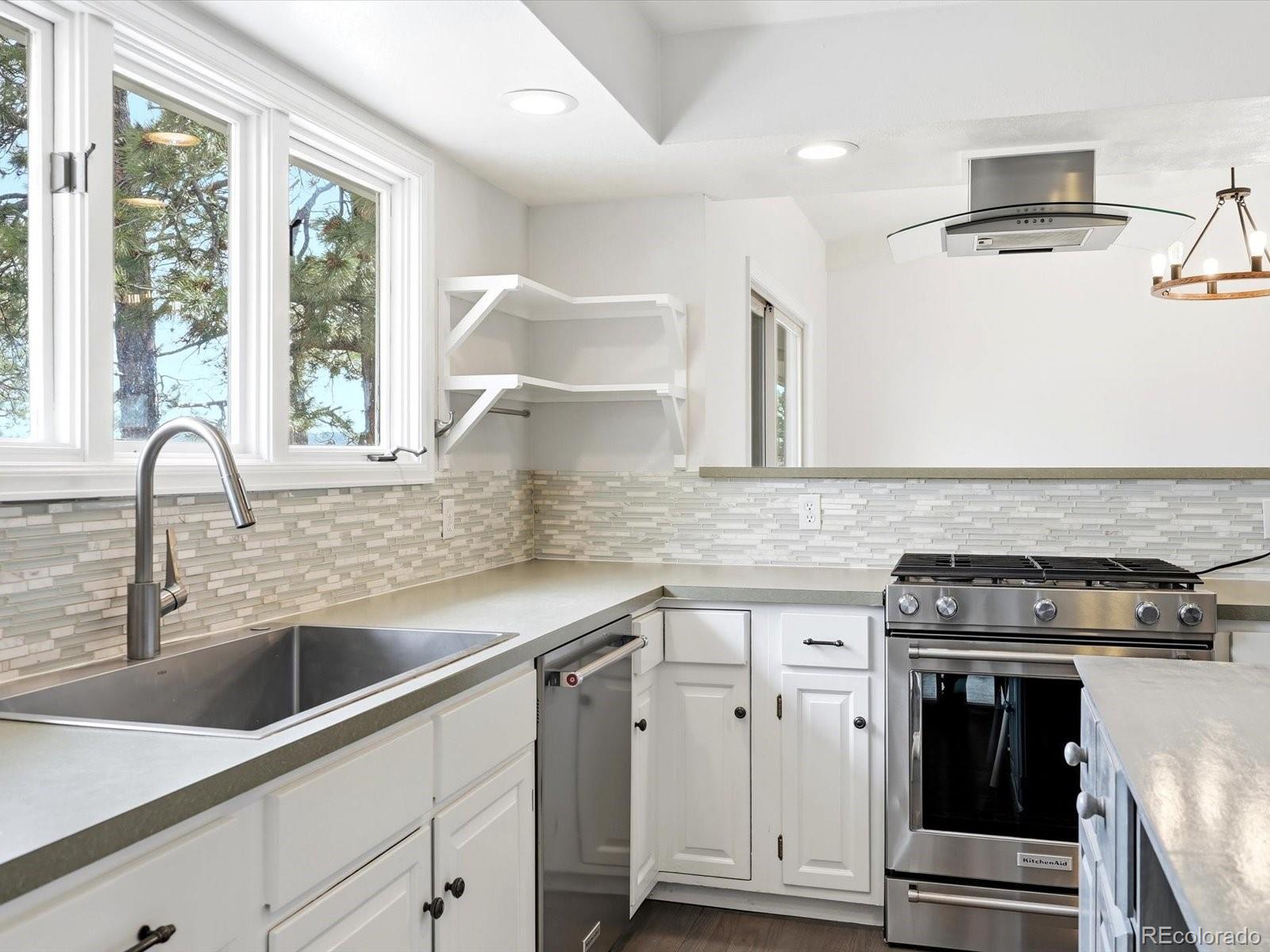 7750 East Greenland Road Franktown, CO 80116 - Photo 25 of 48 a kitchen with granite countertop a sink stainless steel appliances and window