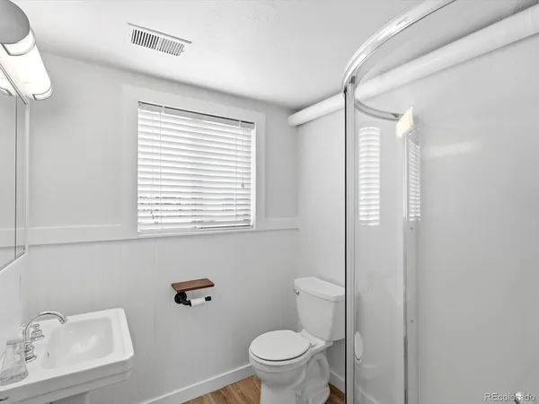 a bathroom with a sink mirror and shower