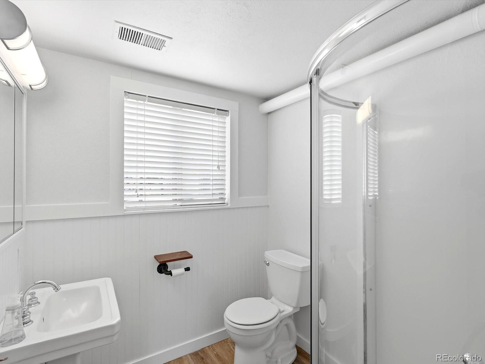 7750 East Greenland Road Franktown, CO 80116 - Photo 27 of 48 a bathroom with a window a sink and a toilet