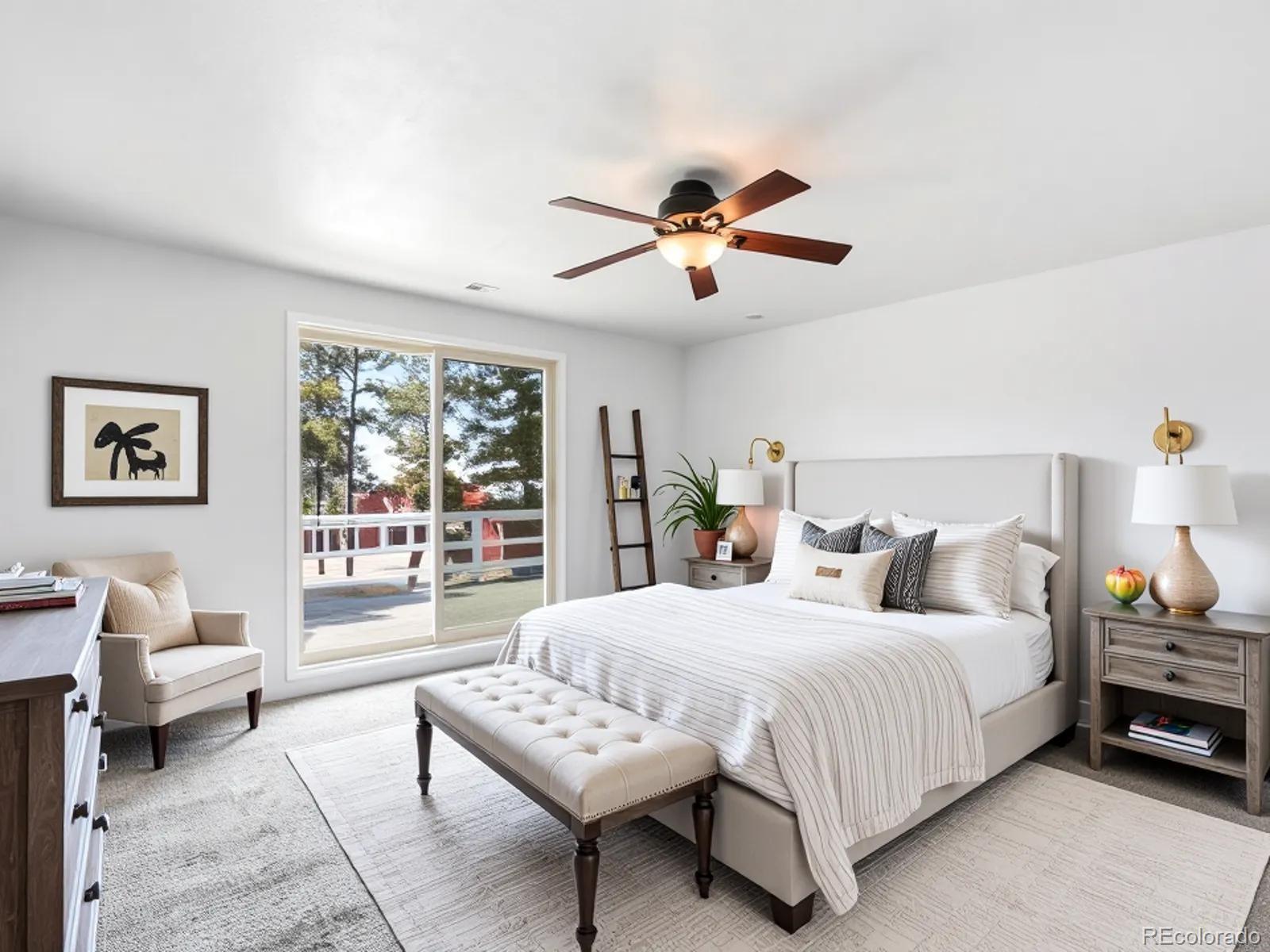 7750 East Greenland Road Franktown, CO 80116 - Photo 29 of 48 a bedroom with a bed a couch and a chandelier