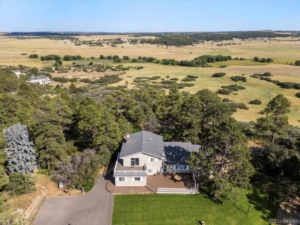 a view of a wooden dinning table and chairs in patio of the house