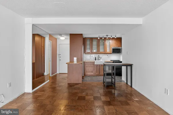 a kitchen with a stove cabinets and a table