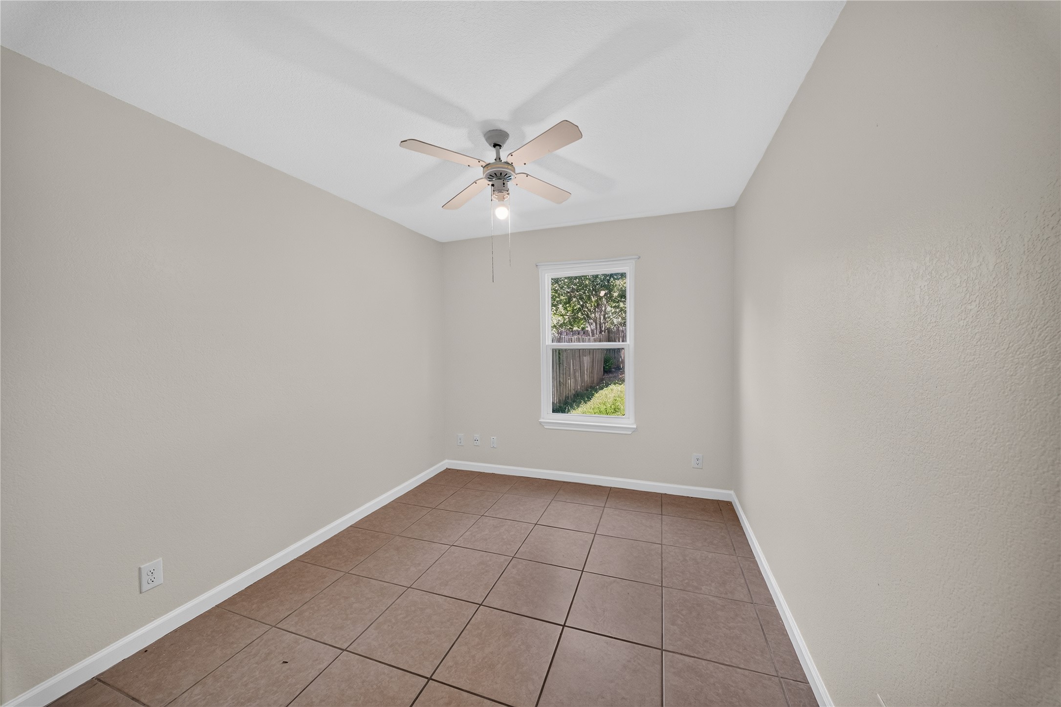339 Fantail Loop, Unit B Austin, TX 78734 - Photo 20 of 21 an empty room with windows and ceiling fan