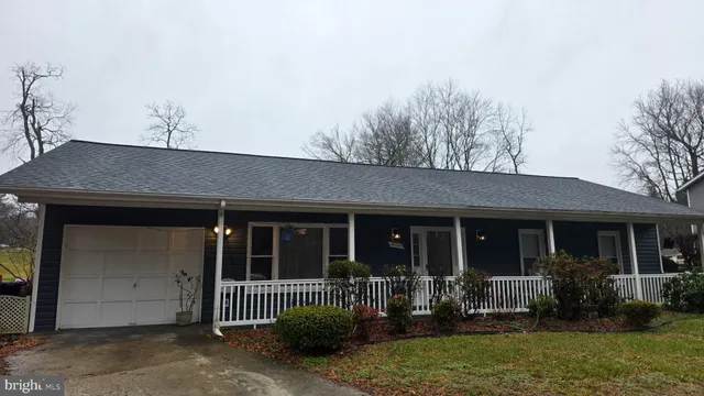 a front view of house with yard and outdoor seating