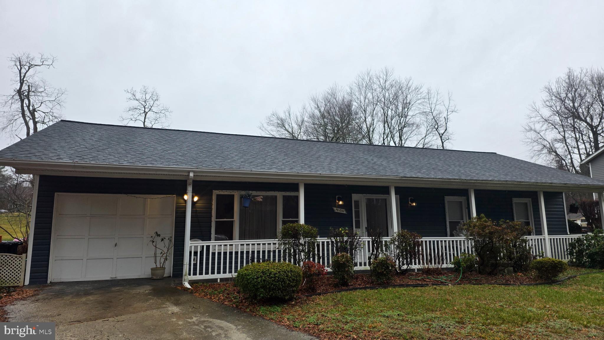 a front view of house with yard and outdoor seating