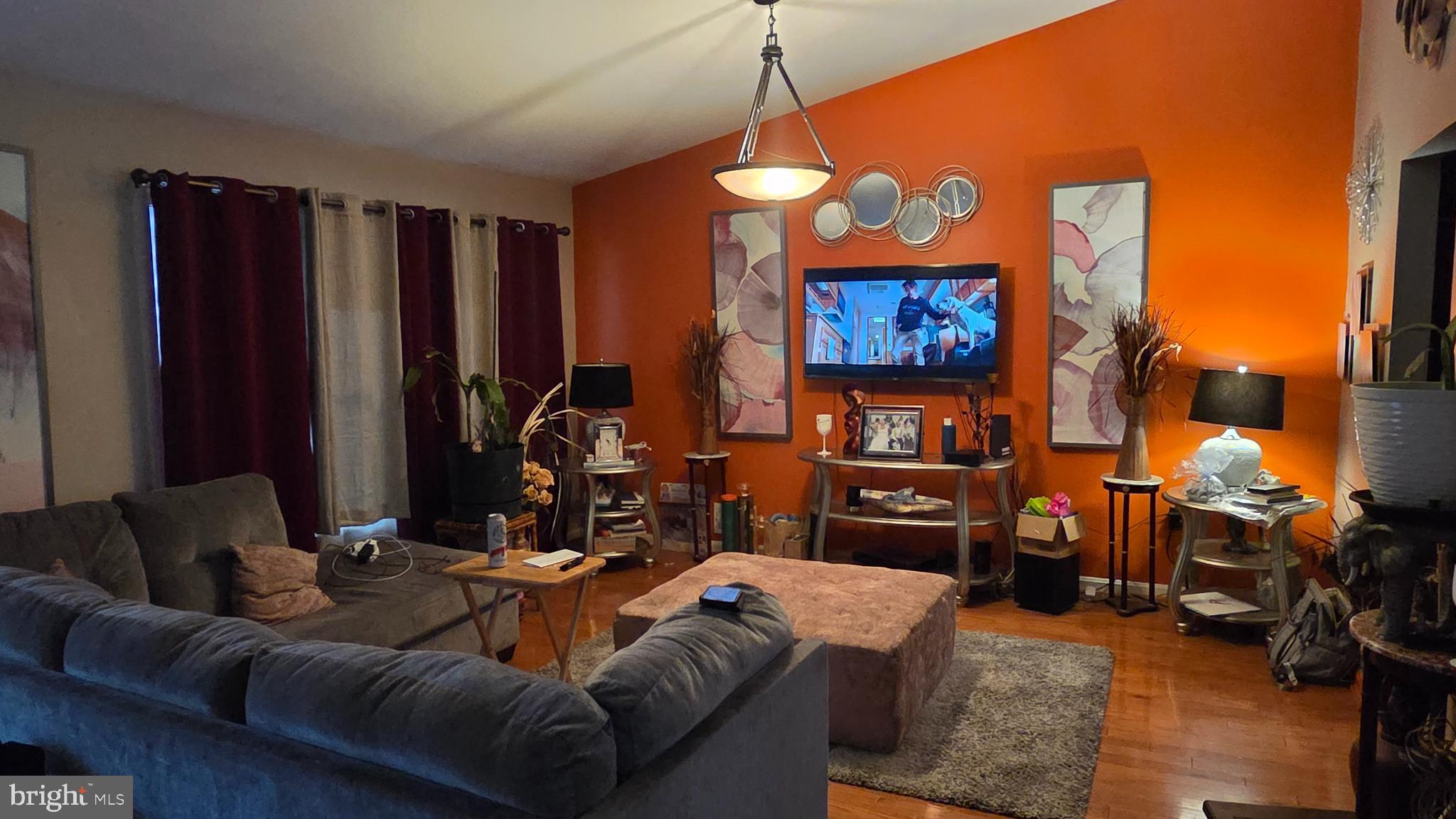 9104 Trumps Hill Road Upper Marlboro, MD 20772 - Photo 4 of 11 a living room with furniture a lamp and a flat screen tv