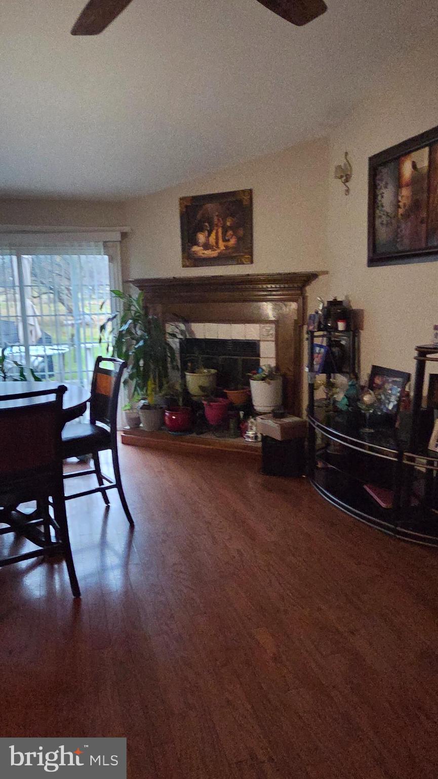 9104 Trumps Hill Road Upper Marlboro, MD 20772 - Photo 6 of 11 a living room with furniture a fireplace and potted plants