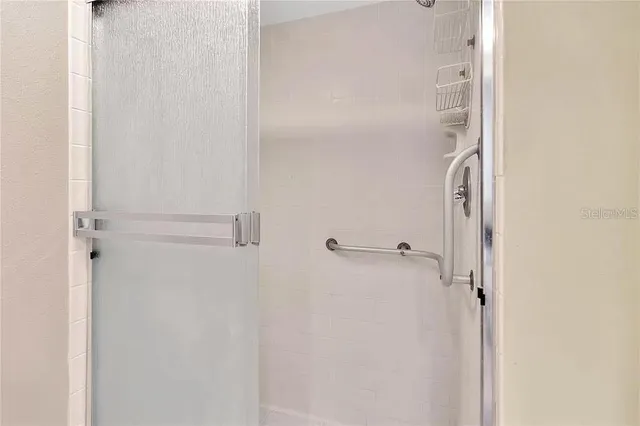 a bathroom with a glass shower door