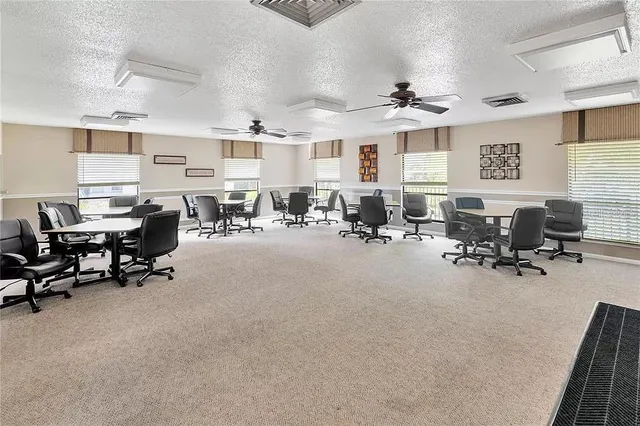 a view of a livingroom with workspace and a window