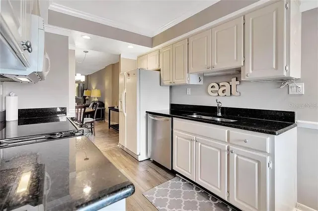 a kitchen with stainless steel appliances a stove a sink and a refrigerator