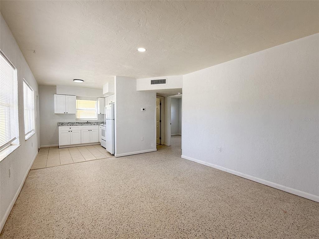 111 177th Avenue West, Unit 3 Redington Shores, FL 33708 - Photo 4 of 16 a view of a big room with windows and chandelier