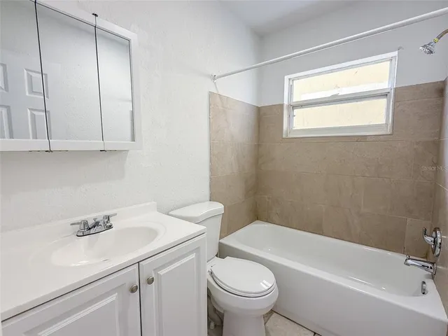 a bathroom with a sink toilet and tub