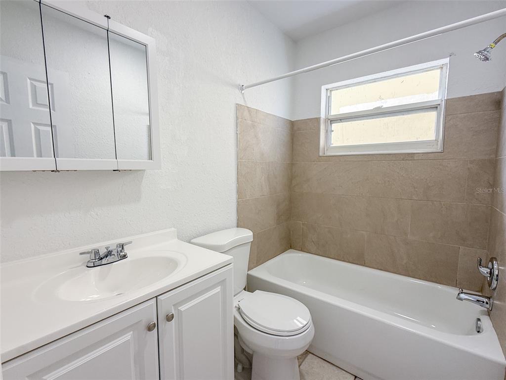 111 177th Avenue West, Unit 3 Redington Shores, FL 33708 - Photo 8 of 16 a bathroom with a sink toilet and tub