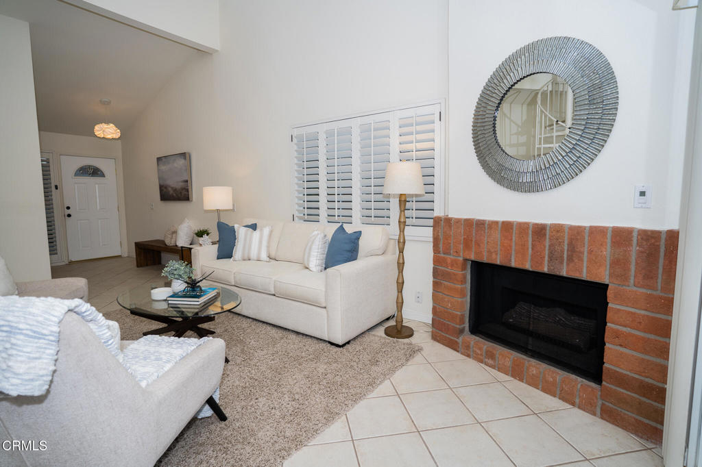4625 Falkirk Bay Oxnard, CA 93035 - Photo 12 of 37 a living room with furniture a fireplace and window