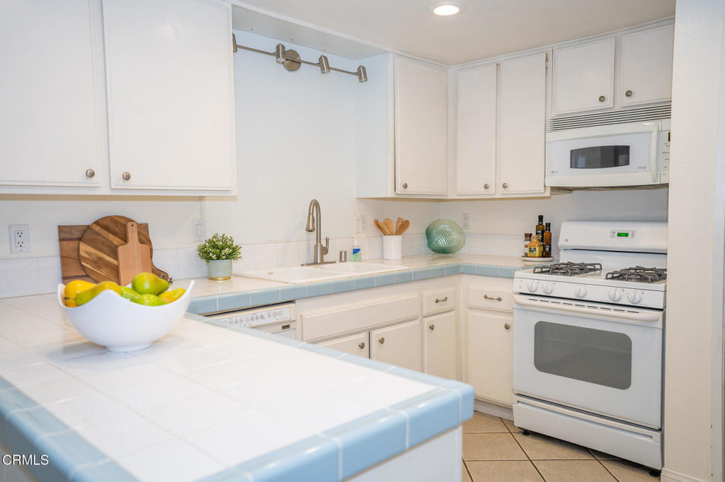 4625 Falkirk Bay Oxnard, CA 93035 - Photo 13 of 37 a kitchen with a white stove top oven and cabinets