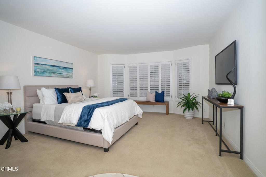 4625 Falkirk Bay Oxnard, CA 93035 - Photo 15 of 37 a spacious bedroom with a bed and a flat screen tv