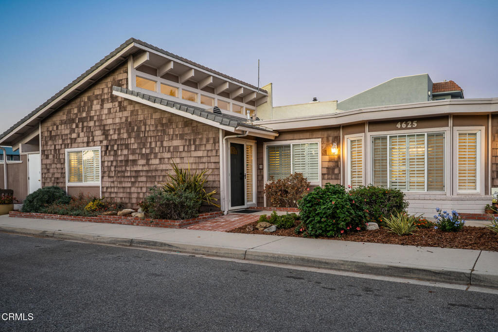 4625 Falkirk Bay Oxnard, CA 93035 - Photo 16 of 37 a front view of a house with a yard and potted plants