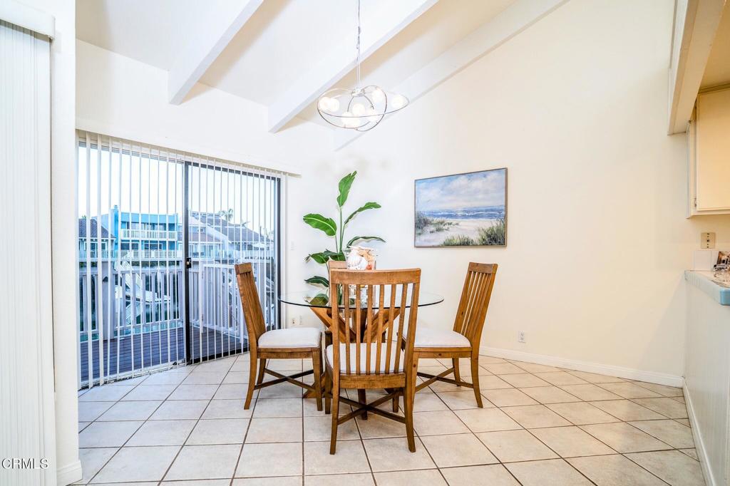 4625 Falkirk Bay Oxnard, CA 93035 - Photo 19 of 37 a view of a dining room with furniture a chandelier and wooden floor