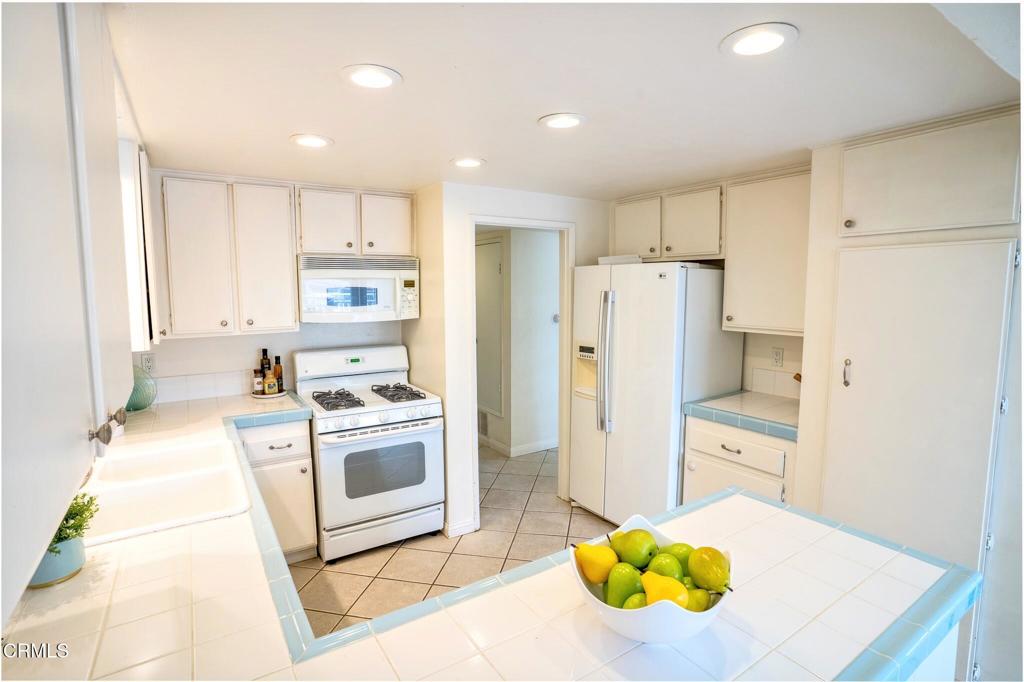 4625 Falkirk Bay Oxnard, CA 93035 - Photo 20 of 37 a kitchen with stainless steel appliances a stove a refrigerator and a cabinets
