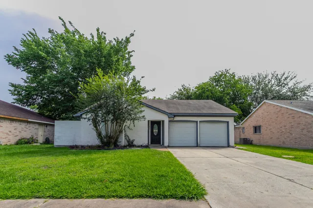 a front view of house with a garden